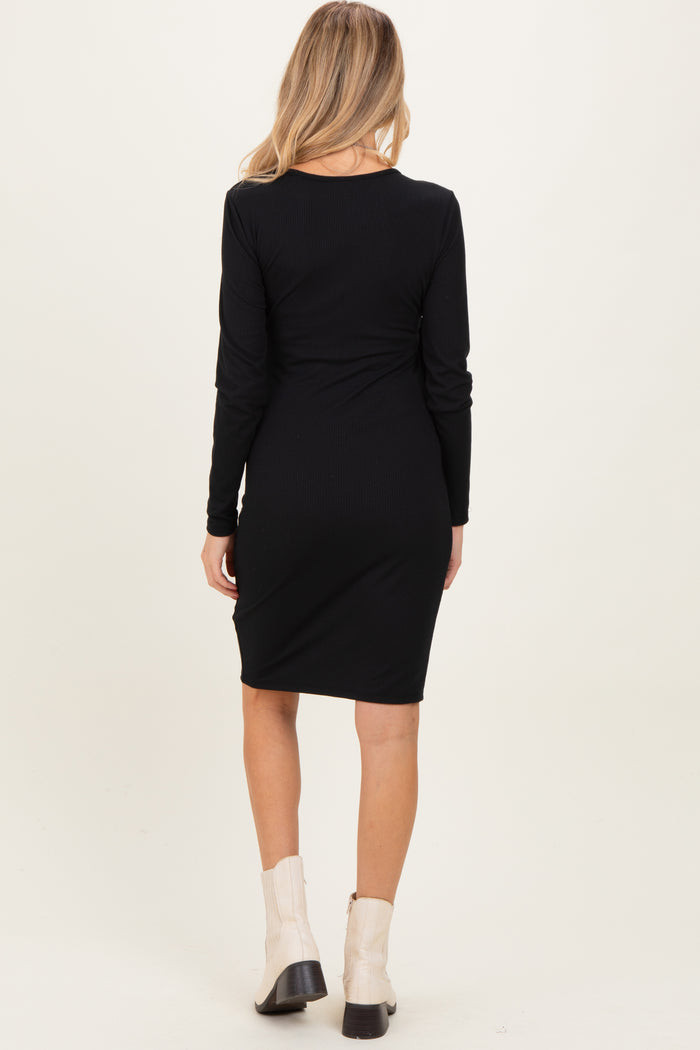 woman wearing a black long sleeve maternity dress with a fitted silhouette, viewed from the back