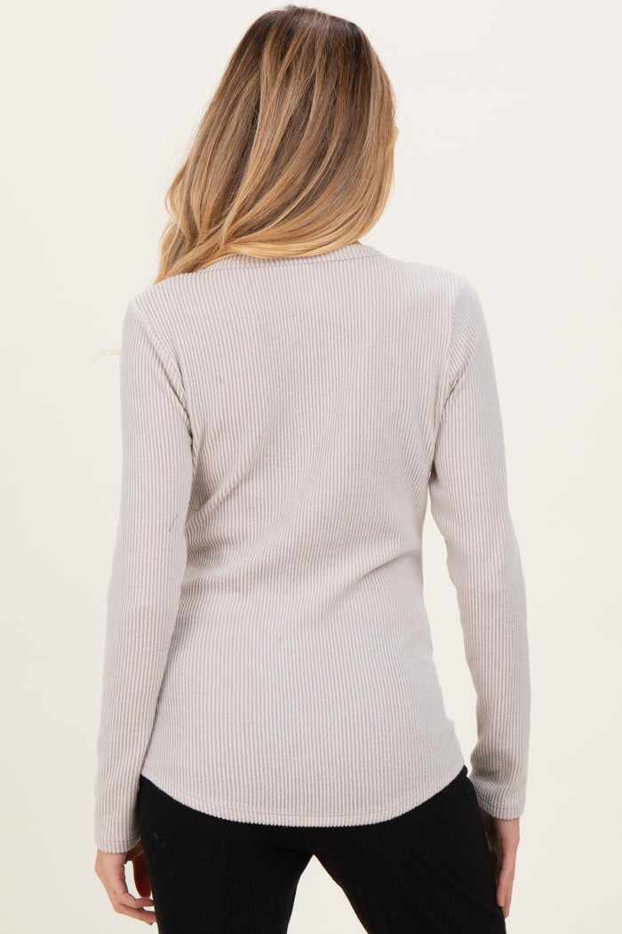 woman wearing a light gray ribbed long sleeve maternity top, showing the back view