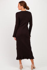 woman wearing a dark brown long sleeve knit dress with ruffled hem иnd back view standing against a plain background