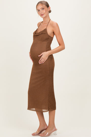 woman wearing a brown sleeveless cowl neck maternity dress highlighting her baby bump