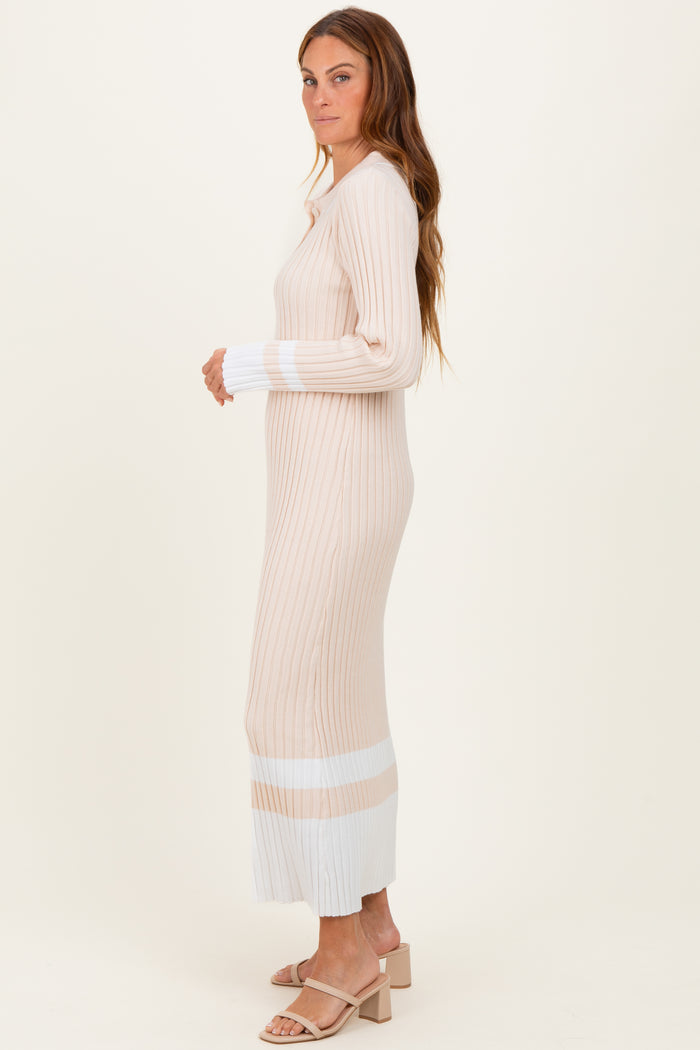 woman wearing a ribbed beige and white long sleeve sweater dress with a fitted silhouette and side slits