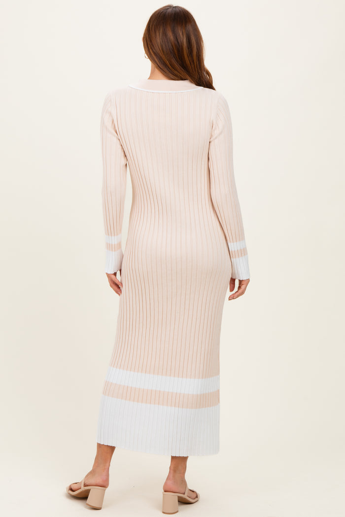 woman wearing a ribbed beige long sleeve midi dress with white stripes at the hem