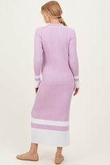woman wearing a light purple ribbed maternity dress with white stripes and a form-fitting silhouette
