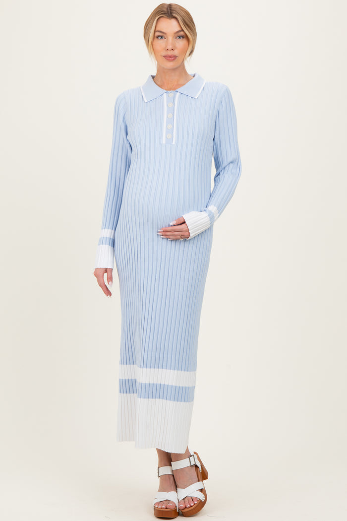 woman wearing a light blue striped maternity dress with a collar and button detail, holding her baby bump