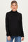 woman wearing a black maternity turtleneck sweater with long sleeves and a relaxed fit, baby bump visible