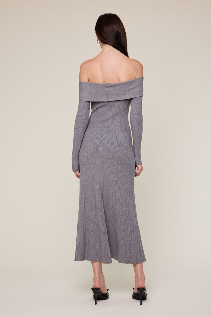 woman wearing a gray off-shoulder ribbed midi dress with long sleeves and a fitted silhouette