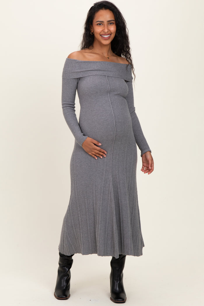 woman wearing a gray off-the-shoulder ribbed maternity dress and holding her baby bump