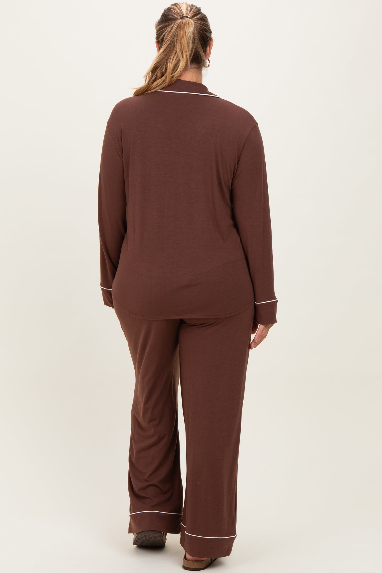 woman wearing a brown maternity plus loungewear set with long sleeves and pants, viewed from the back