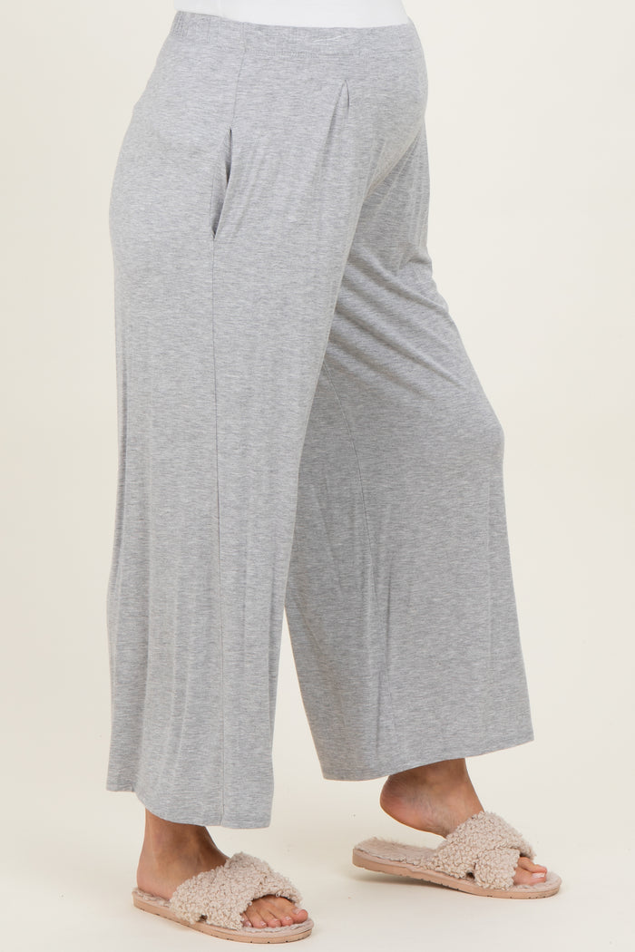 woman wearing gray maternity wide-leg pants with a comfortable waistband and a visible baby bump