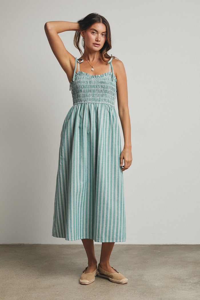 woman wearing a teal and white striped midi dress with smocked bodice and tie straps