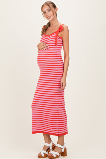 woman wearing a red and white striped maternity maxi dress with tie details, showing her baby bump