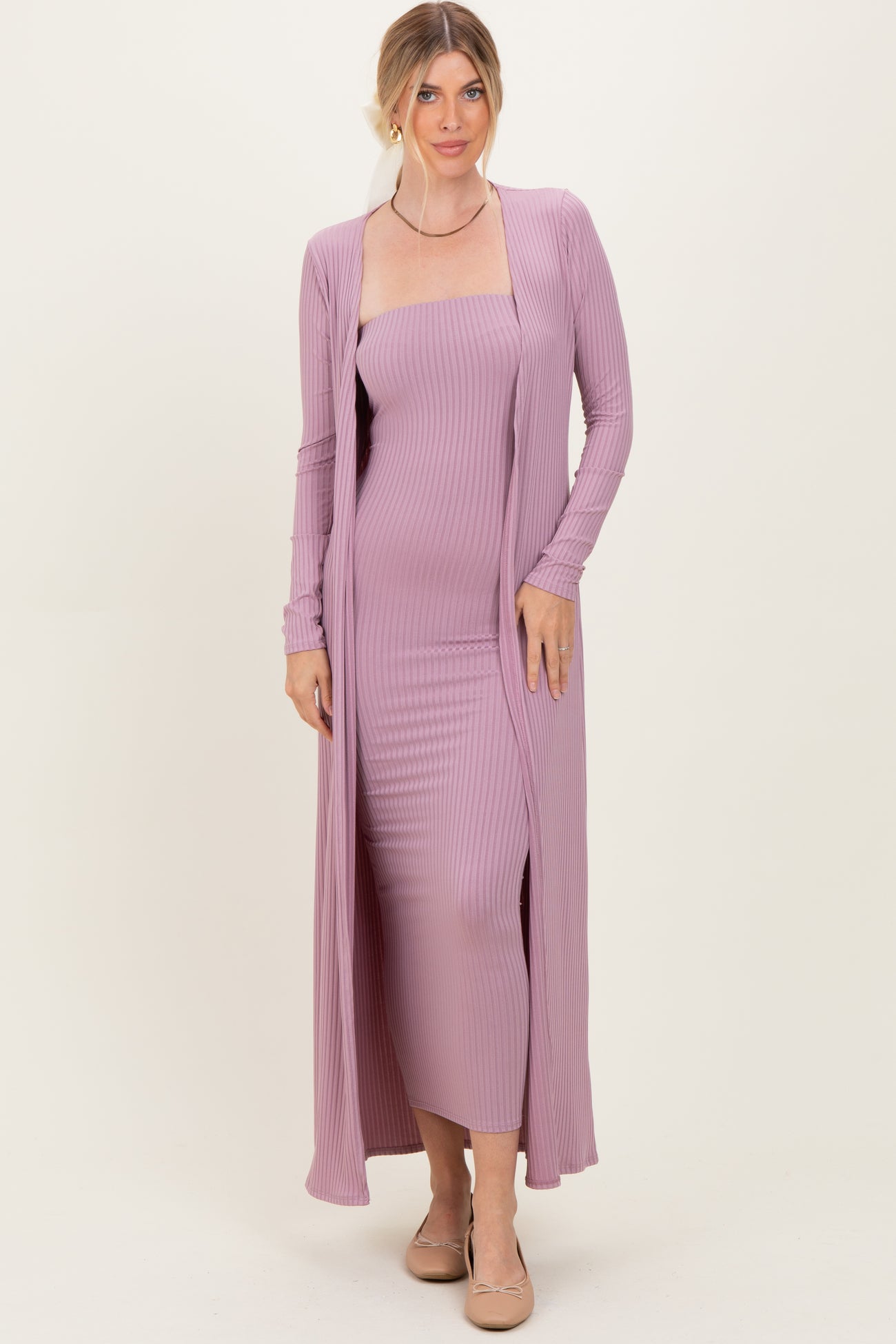 woman wearing a lavender ribbed midi dress with a long cardigan and a fitted silhouette