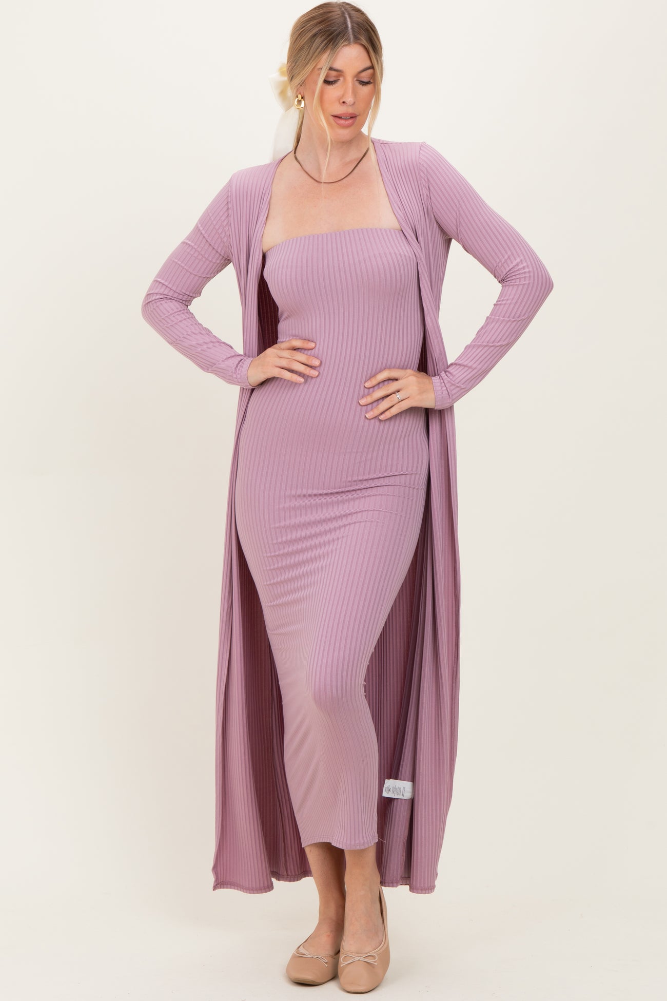 woman wearing a light mauve ribbed maxi dress with a long matching cardigan