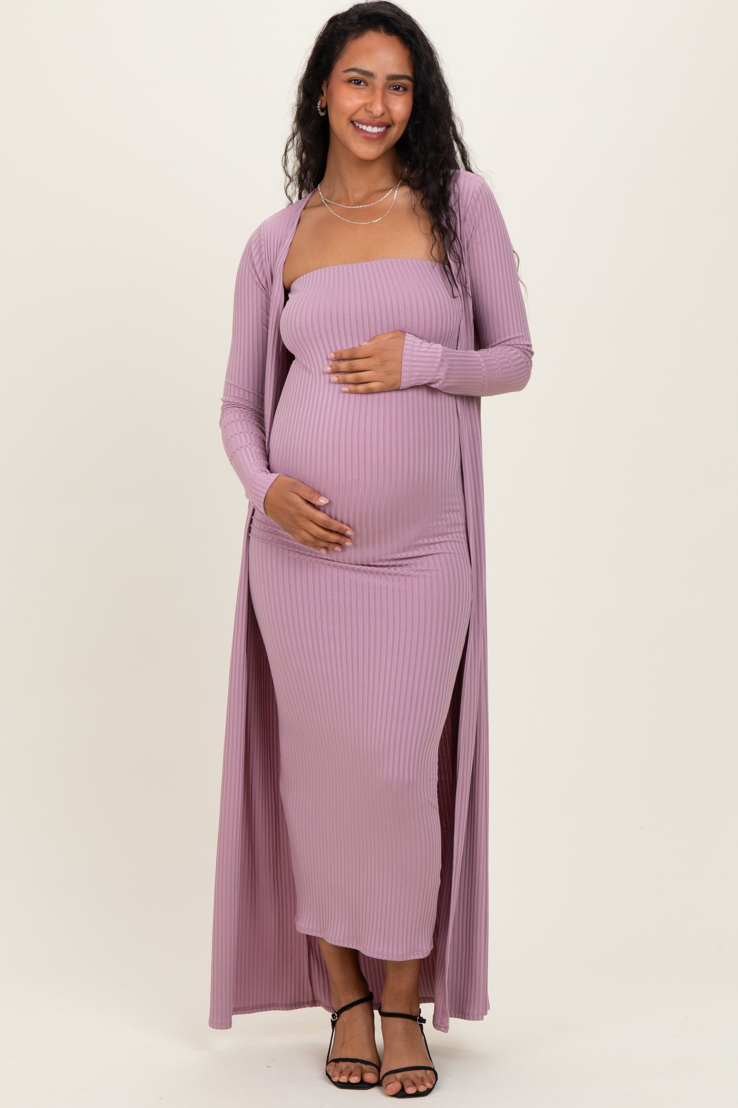 woman wearing a lavender ribbed maternity dress with a long cardigan and a visible baby bump