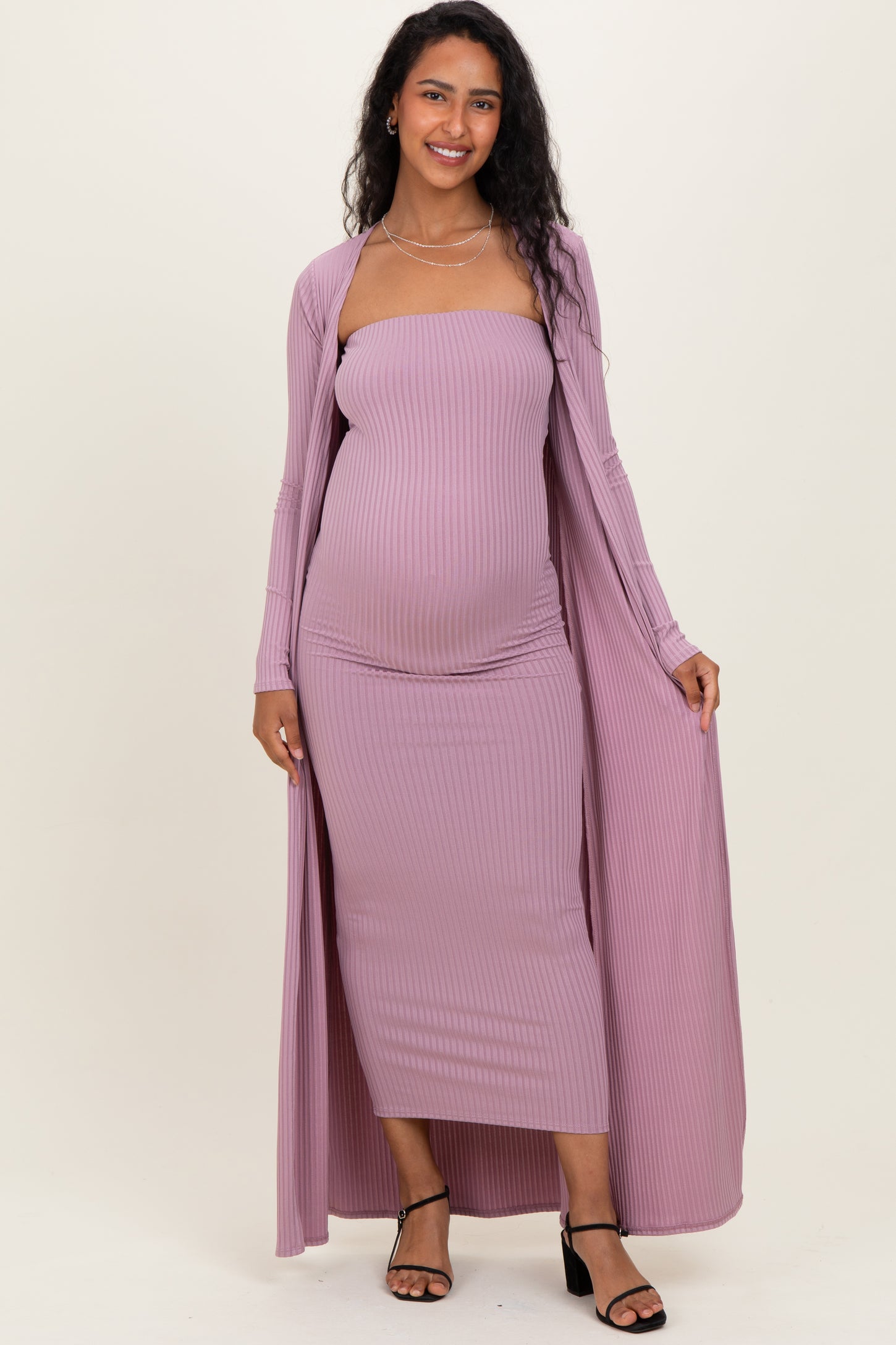woman wearing a lavender ribbed maternity dress with a matching long cardigan and visible baby bump