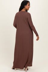 woman wearing a long brown ribbed maternity dress, featuring long sleeves and a relaxed fit