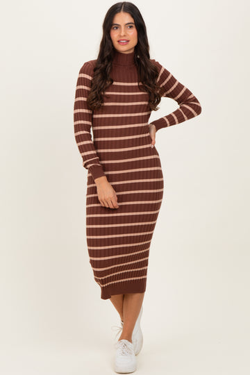woman wearing a brown striped long sleeve ribbed midi dress with a high neck and white sneakers