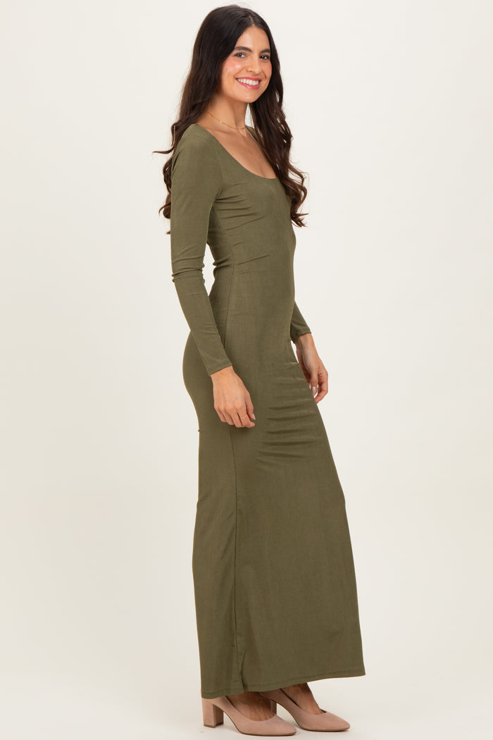 woman wearing a long sleeve olive green maxi dress with a fitted silhouette and side gathering