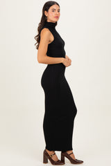woman wearing a black ribbed maxi dress with a high neckline and sleeveless design