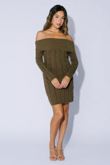 woman wearing an olive green off-shoulder cable knit sweater dress with long sleeves and a fitted silhouette