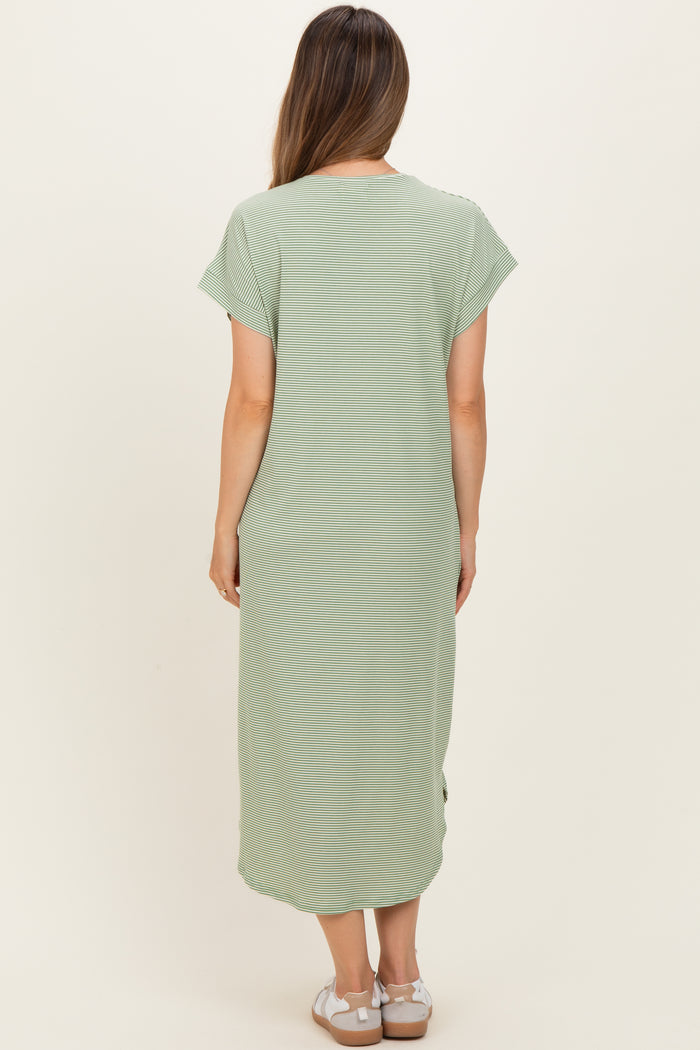 woman wearing a light green maternity maxi dress with short sleeves and side slits, shown from the back