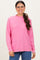 woman wearing a pink long sleeve oversized sweater with a high neckline and relaxed fit