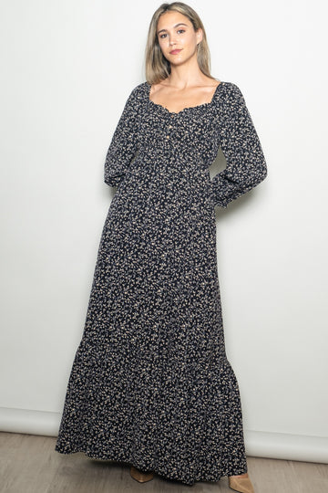 woman wearing a navy floral long sleeve maxi dress with a square neckline and button details