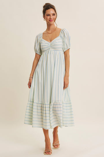 woman wearing a light blue and white striped puff sleeve midi dress with a square neckline and tiered skirt