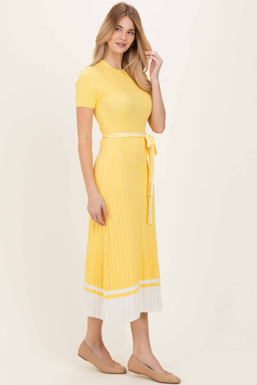 woman wearing a yellow ribbed midi dress with short sleeves and a belted waist, featuring white stripe at the hem