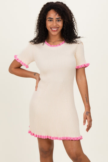 woman wearing a cream short sleeve ribbed dress with pink ruffled trim