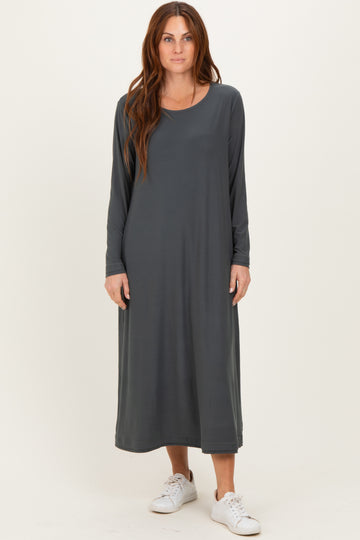 woman wearing a long grey maxi dress with long sleeves and a relaxed fit