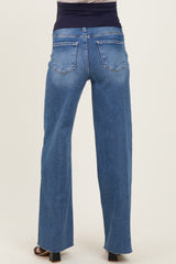 woman wearing blue maternity jeans with a high waist and wide-leg style, showing the back view