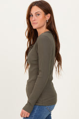 woman wearing an olive green ribbed long sleeve top with a round neckline and button details