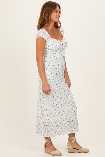 woman wearing a white floral maxi dress with puff sleeves and a square neckline, paired with espadrille wedges