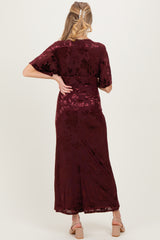 woman wearing a burgundy floral print maternity maxi dress, showing the back view with flowy sleeves