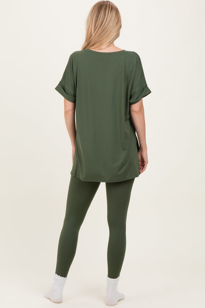 woman wearing an oversized green t-shirt with rolled sleeves and matching green leggings, viewed from the back