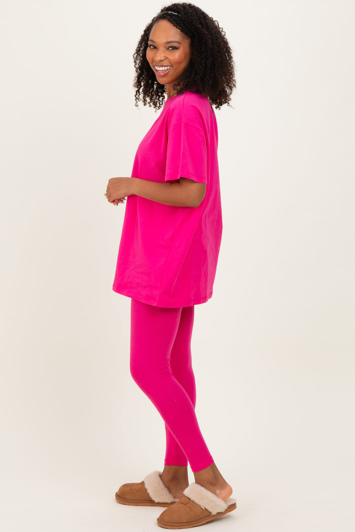 woman wearing a bright pink oversized t-shirt and matching leggings, styled with brown fluffy slippers