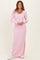 woman wearing a light pink long sleeve ribbed maxi dress with side slits and white sneakers