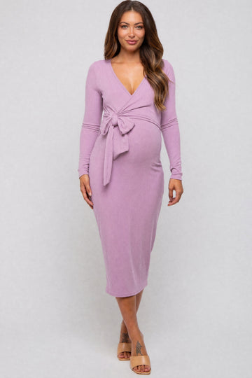 woman wearing a lavender long sleeve maternity dress with a tie waist and a visible baby bump