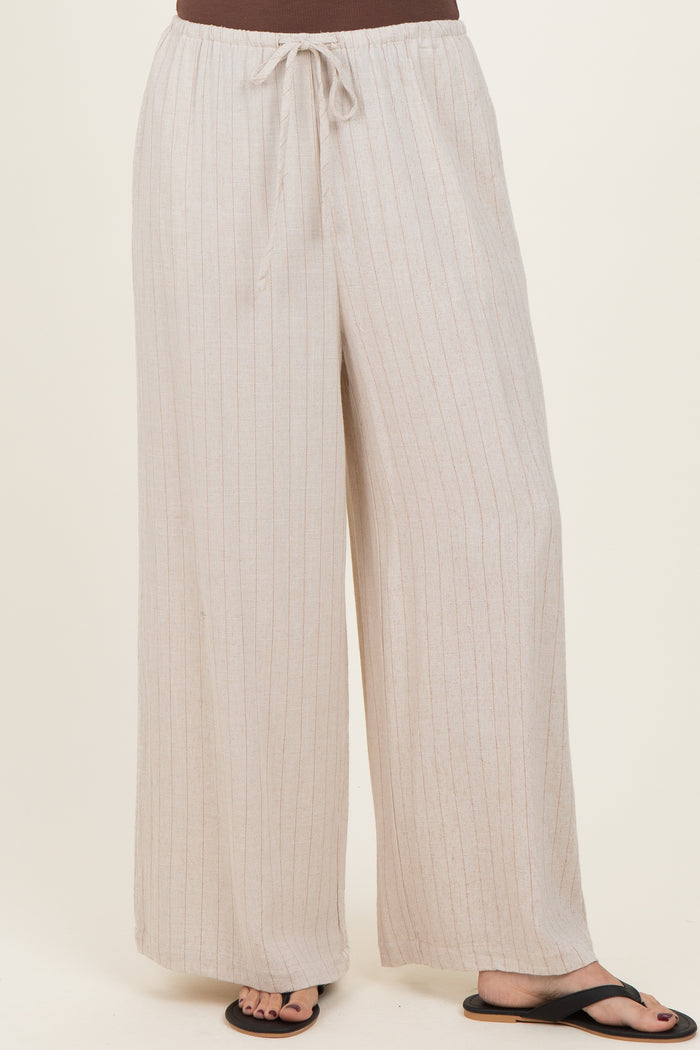 woman wearing beige striped wide-leg pants with an elastic waistband and drawstring detail