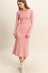 woman wearing a pink striped long sleeve midi dress with a flared hem and fitted bodice