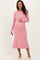 woman wearing a pink and white striped maternity dress and holding her baby bump