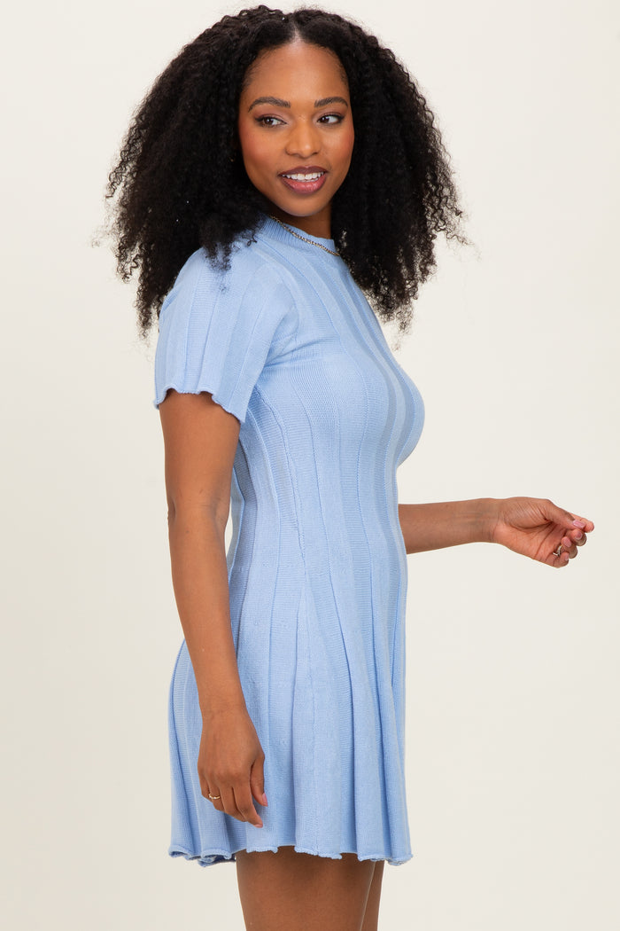 woman wearing a light blue short sleeve ribbed dress with a flared skirt and scalloped hem