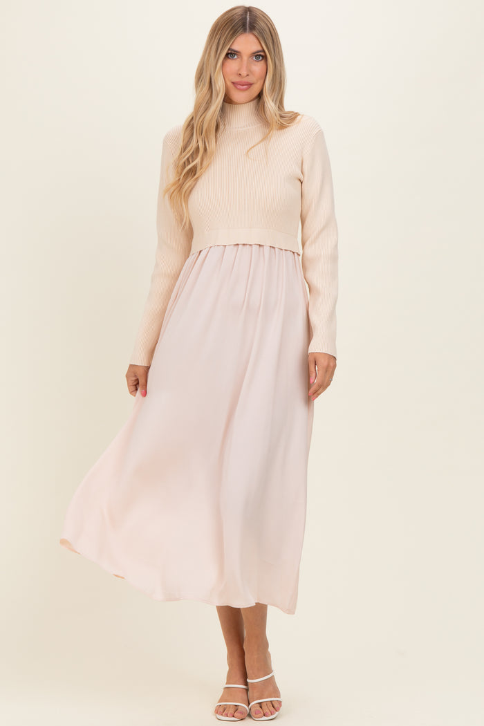 woman wearing a cream ribbed long sleeve top with a flowing blush maxi skirt