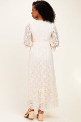 woman wearing a cream lace maxi dress with long sleeves viewed from the back