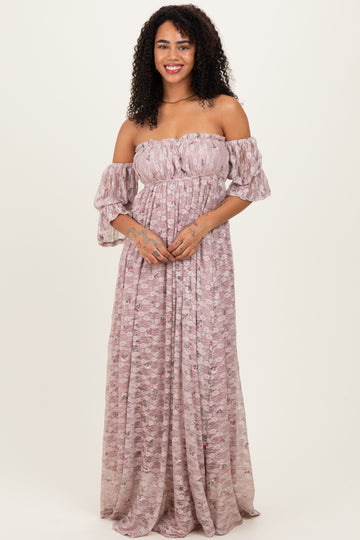 woman wearing a pink off-shoulder maxi dress with puff sleeves and a floral pattern