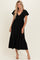 woman wearing a black tiered maxi dress with a v-neck and short puff sleeves