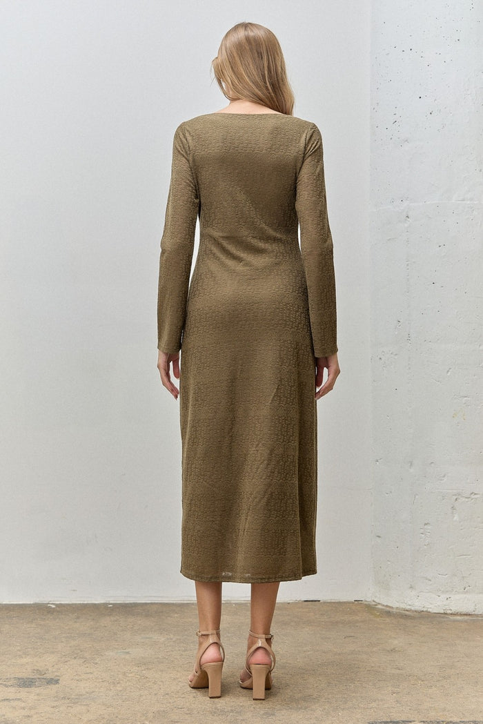 woman wearing a long sleeve olive green midi dress, shown from the back, styled with high-heeled sandals