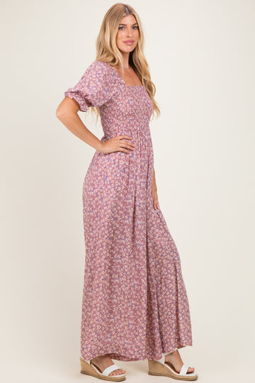 woman wearing a lilac floral maxi dress with puff sleeves and a fitted bodice, standing in profile