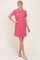 woman wearing a short sleeve pink ribbed t-shirt dress and beige slip-on shoes